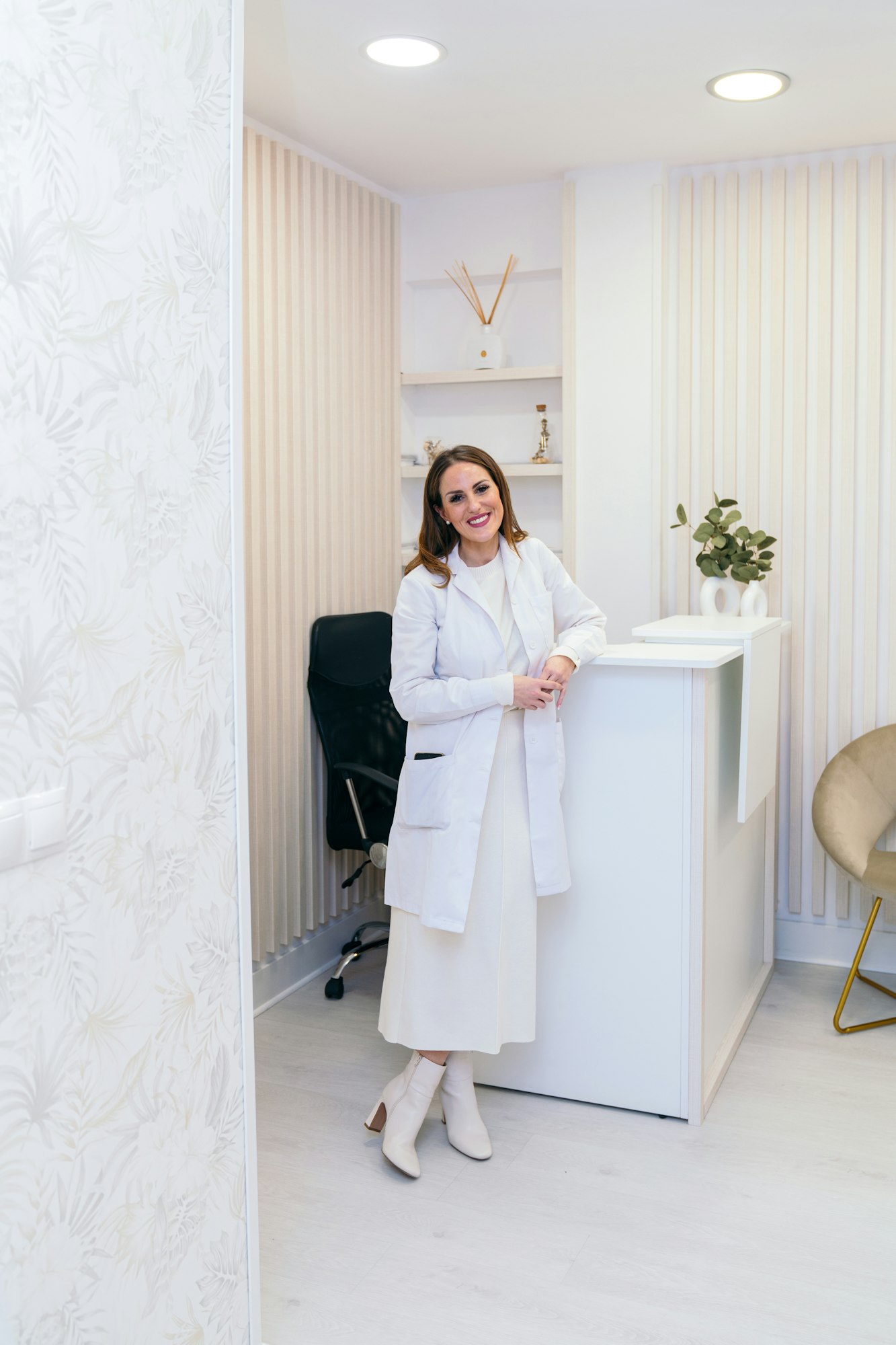 Smiling Professional Woman in White at Aesthetic Clinic