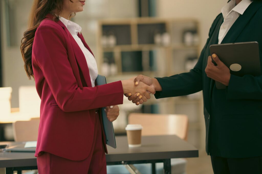 Businesswoman handshake with partner to celebration partnership and business deal concept.