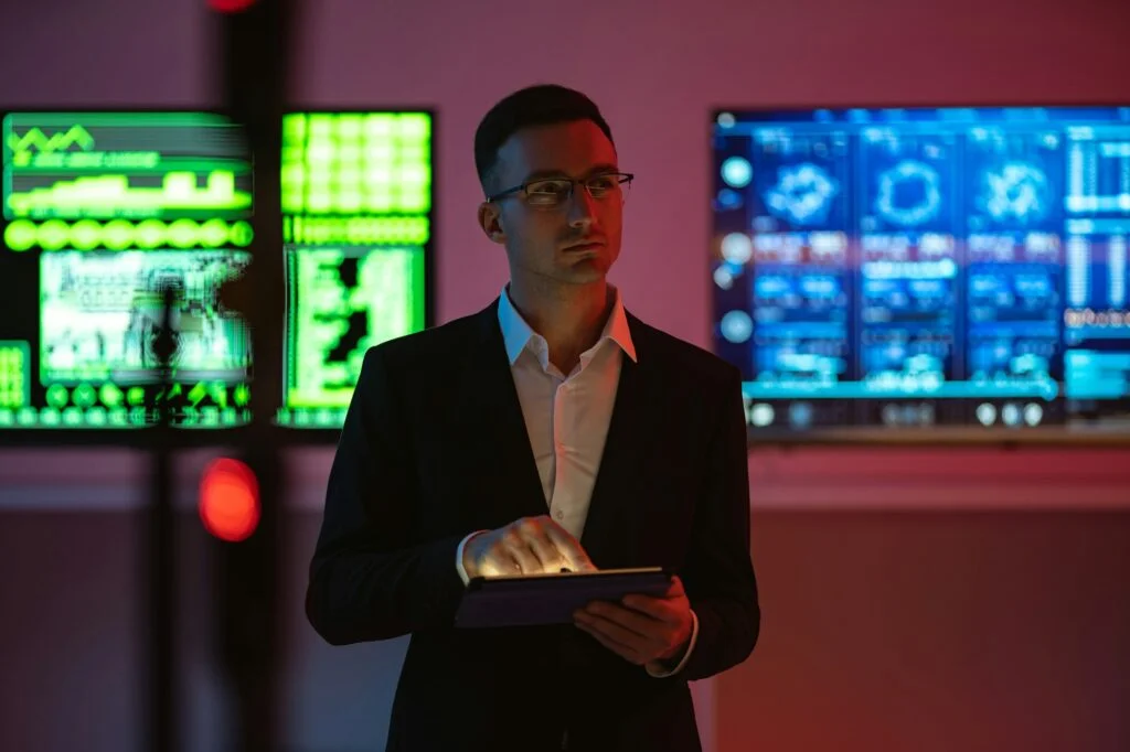 Businessman standing with security data screen behind